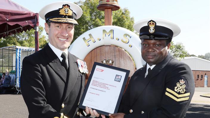 PO Cyprone Barrett receiving award from Rear Admiral Paul Methven