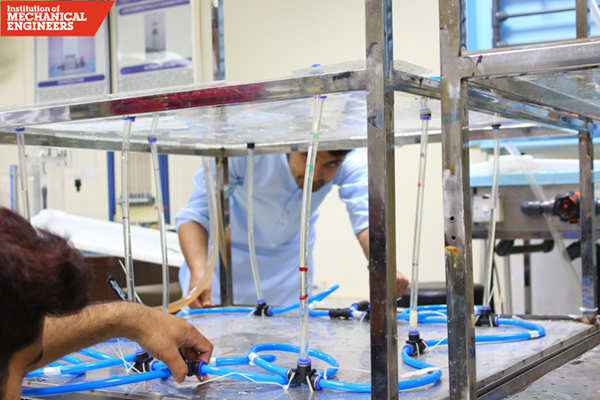 Students connecting their piping system before their demonstration