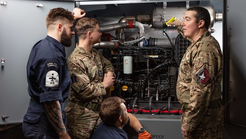 Corporal Vyse showing Navy AED personnel the engine, describing each component and then how it powers the rig.
