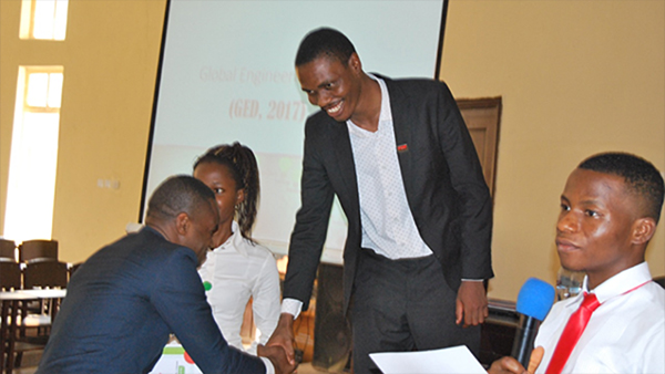 Udoye Springs Chinedu; the Winner of the debate being presented with his prize and certificate for his speech titled “Transport technologies for the ageing population”