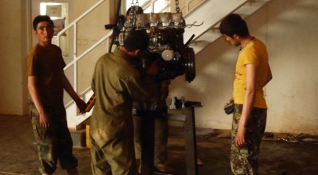 Afghan troops fix an ambulance engine At work