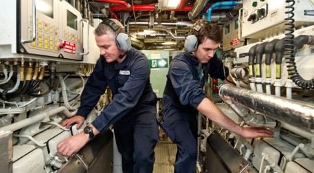 Workers checking diesels on board Ambush, prior to running Article image